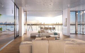 large spacious living room with white couch, glass coffee tables, and an open balcony with outdoor furniture at Monad Terraces