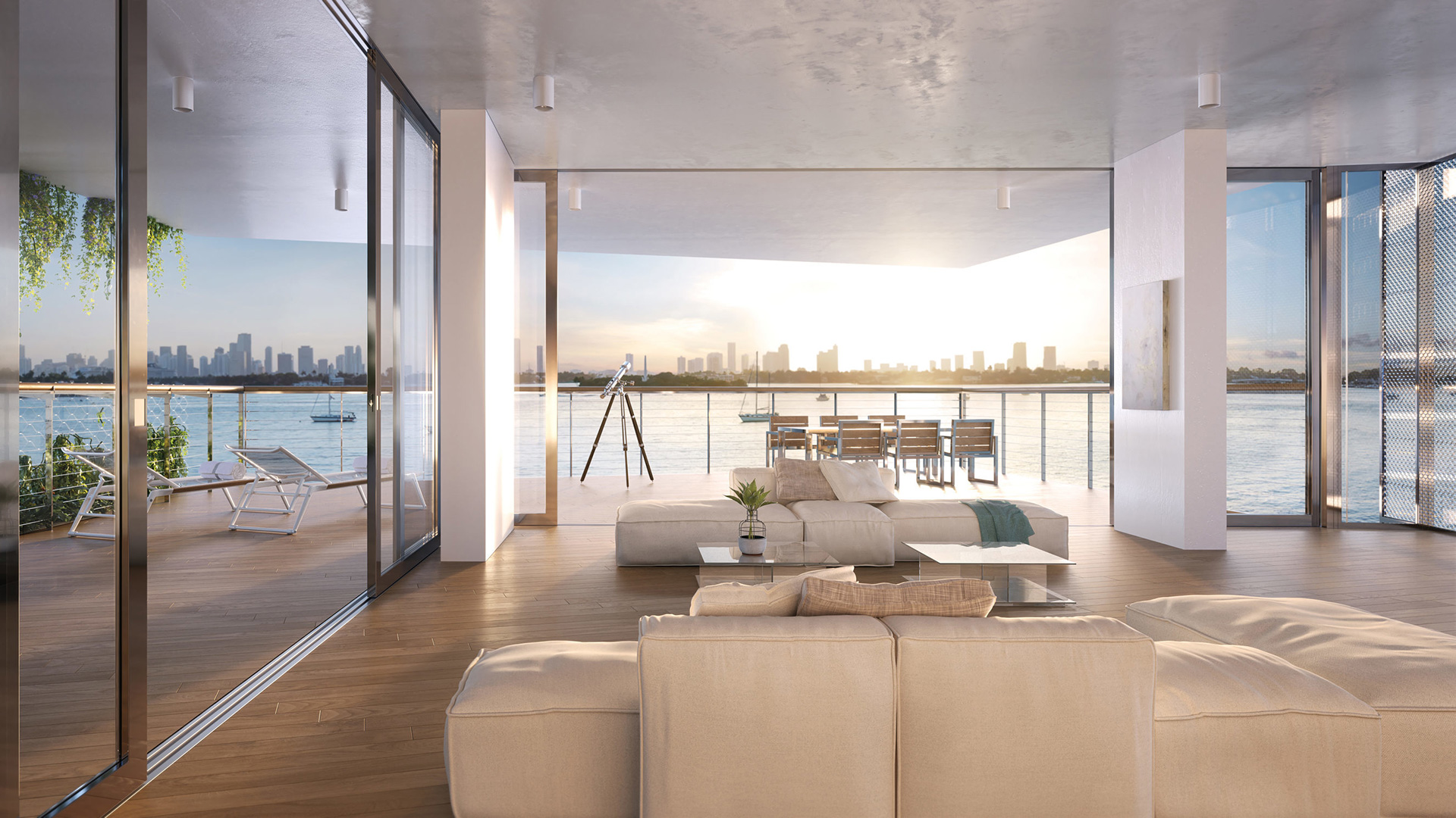 Large spacious living room with all white interior, glass coffee table, and outdoor seating facing the beautiful Biscayne Bay at Monad Terraces