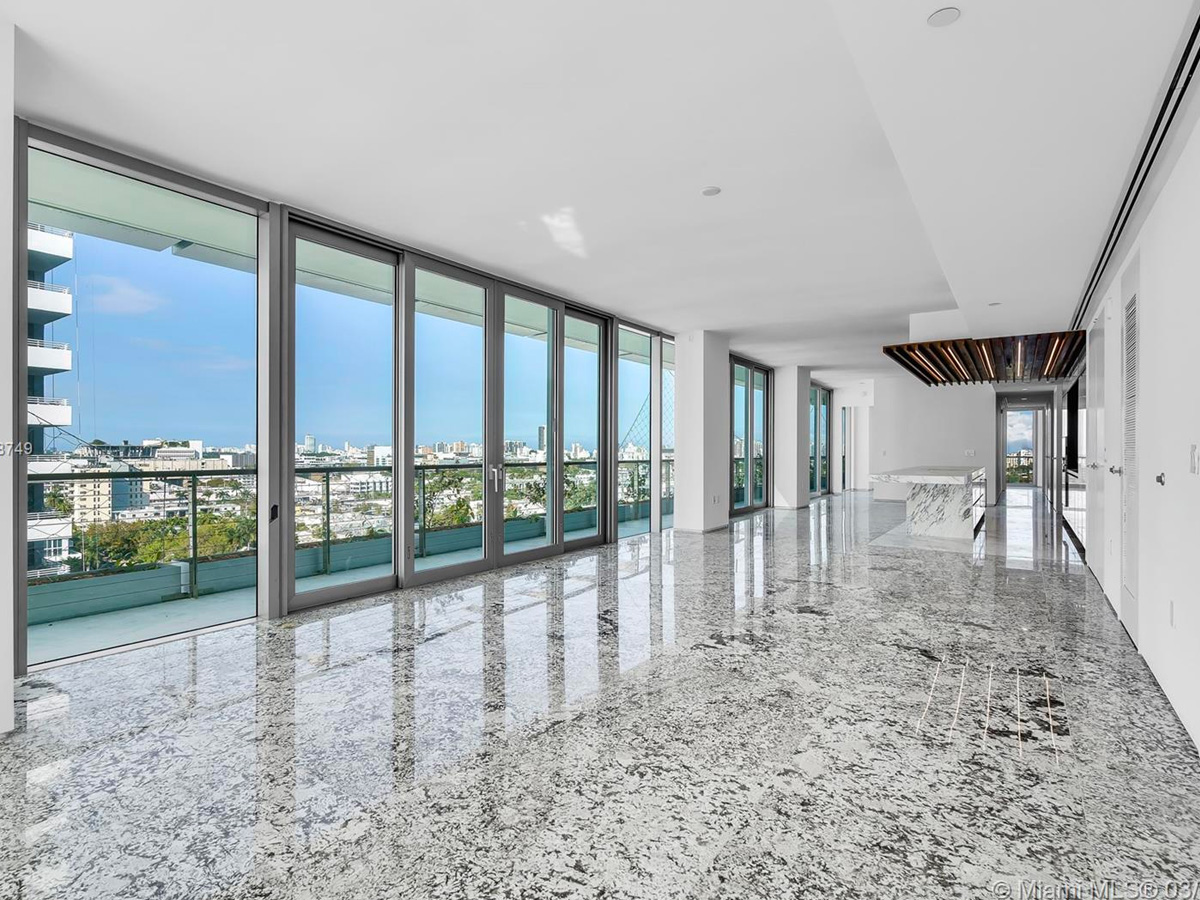 Large open room with marble floors inside Monad Terraces overlooking Biscayne Bay